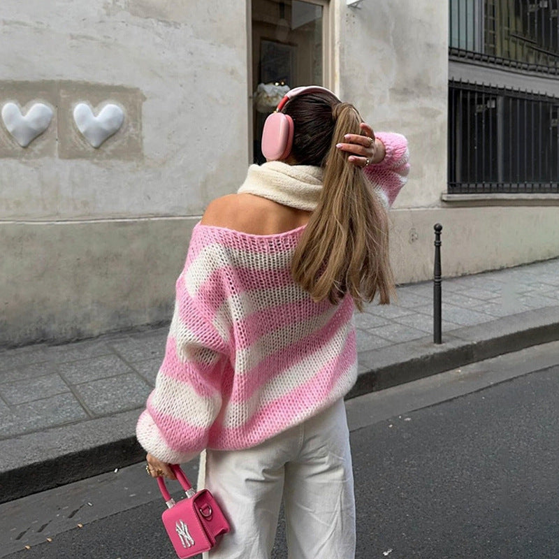 Striped sweater in pink and white stripes worn off the shoulder