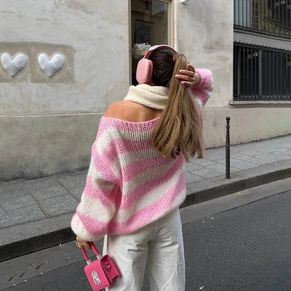Striped sweater in pink and white stripes worn off the shoulder