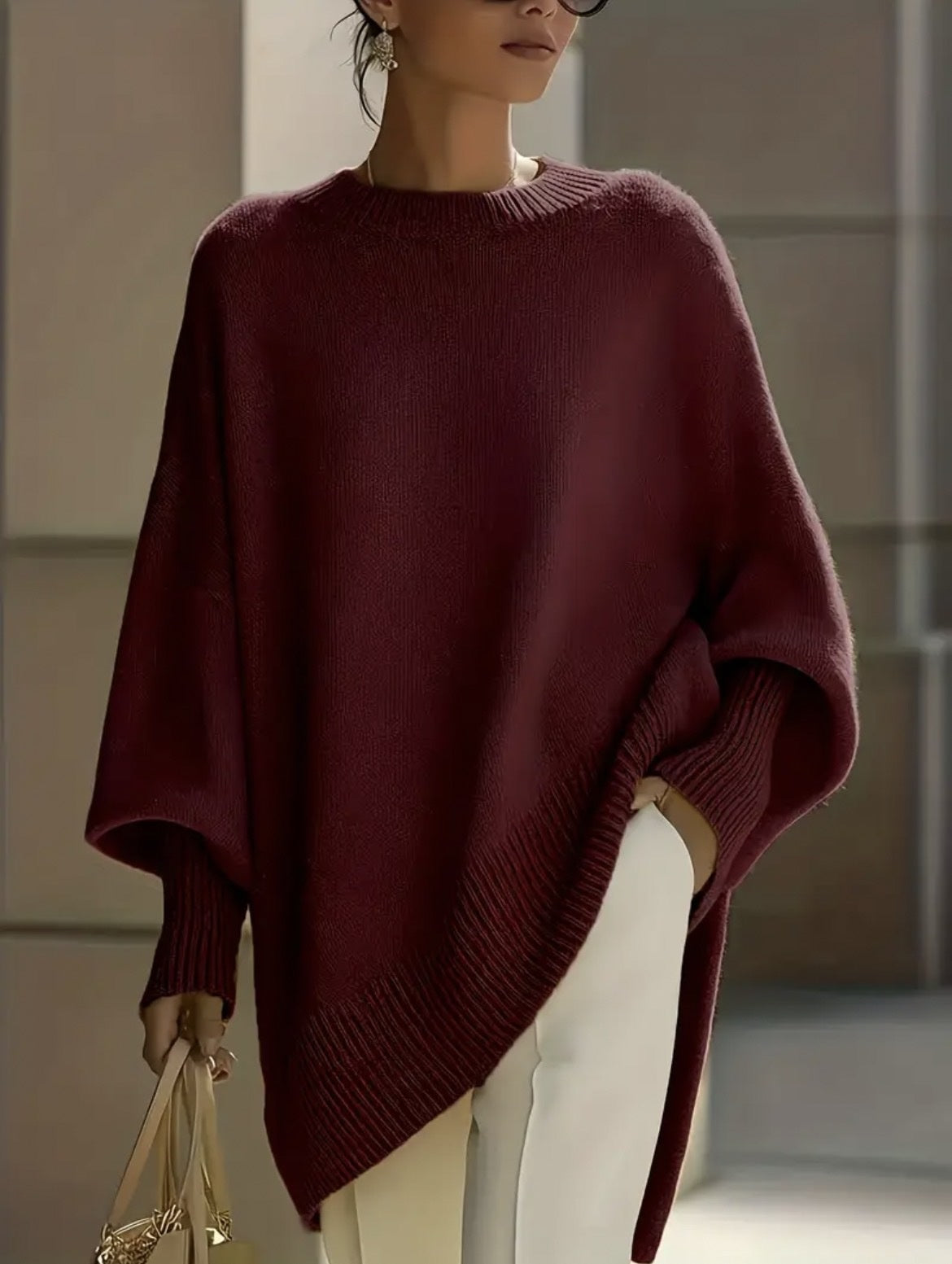 Relaxed round-neck knit sweater in wine red, front view with side slits