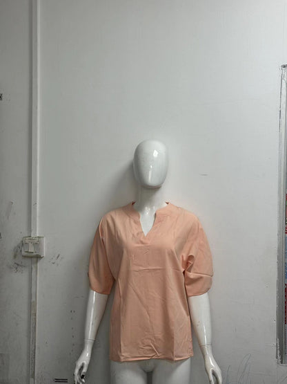 Split-neck blouse in peach on a mannequin