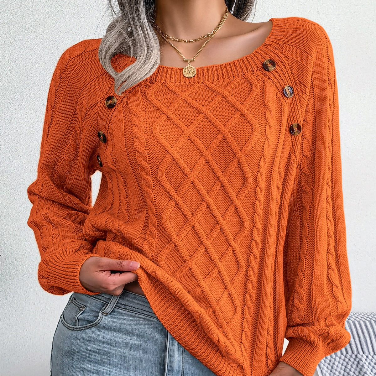 Button-detail cable-knit sweater in orange