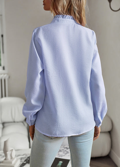 Back view of the ruffle-trim blouse in blue and white stripes
