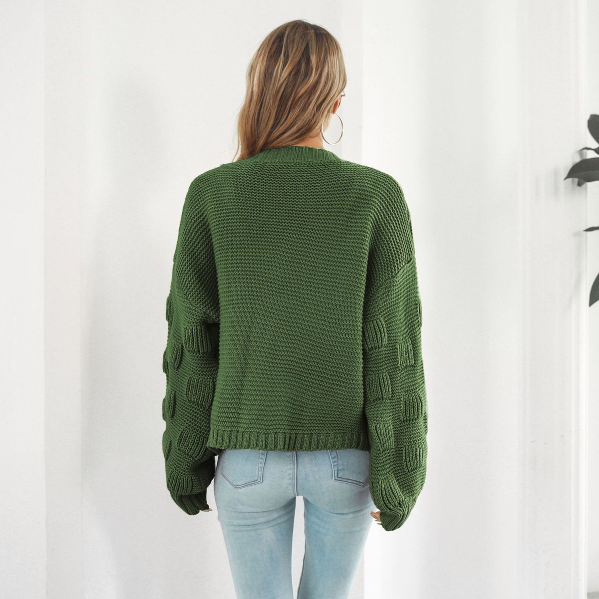Back view of the balloon-sleeve cardigan in army green