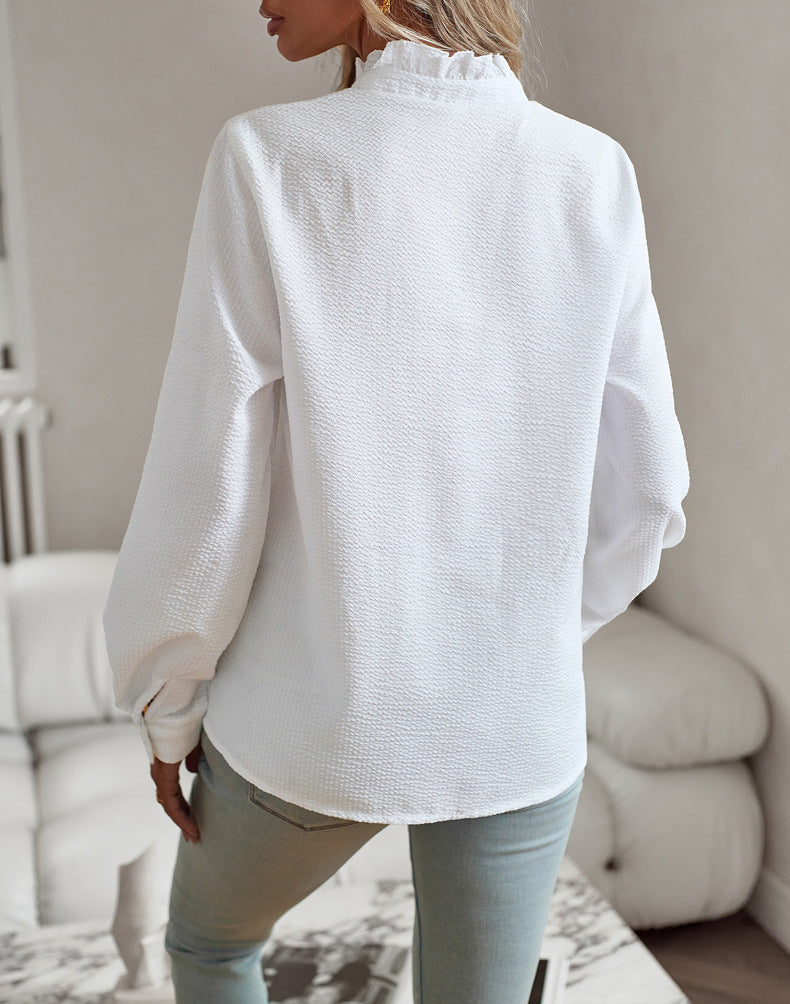 Back view of the ruffle-trim blouse in white
