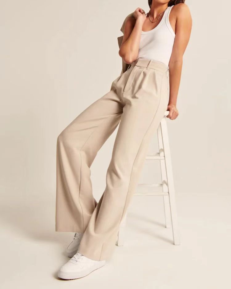 Pleated tailored trousers in cream, styled