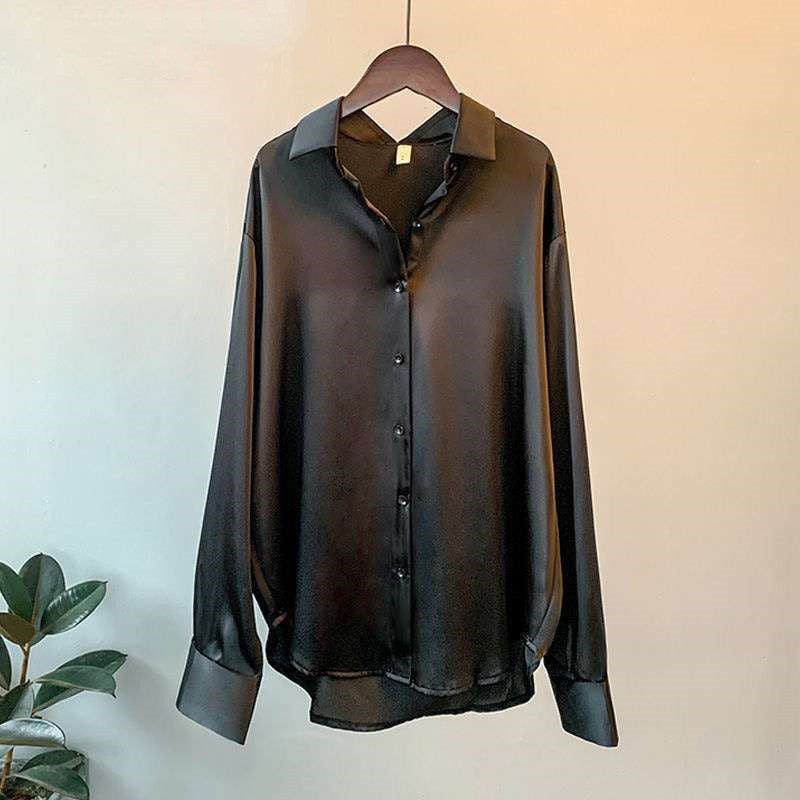 Satin-effect button-up shirt in black on a hanger