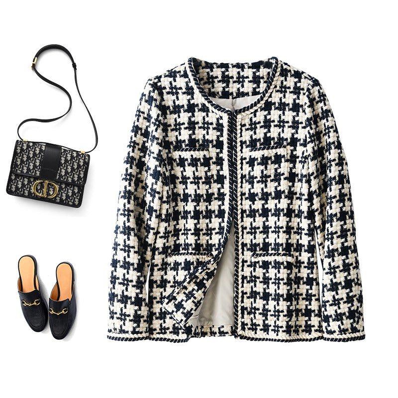 Houndstooth jacket laid flat with a bag and shoes