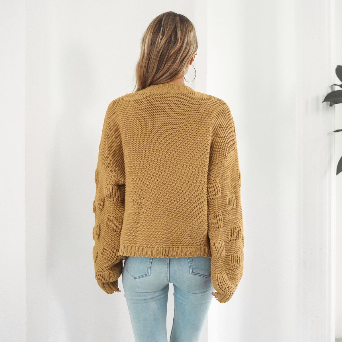 Back view of the balloon-sleeve cardigan in mustard yellow