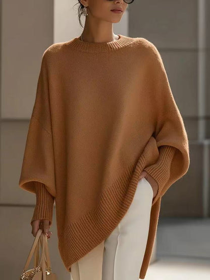 Relaxed round-neck sweater in coffee (tan), worn with cream trousers