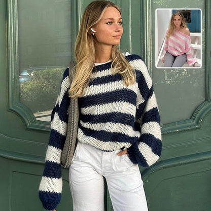 Striped crew-neck sweater in navy and white stripes, seated