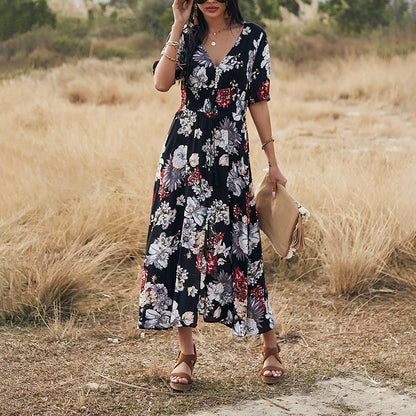 Floral day dress with a black ground print, full length