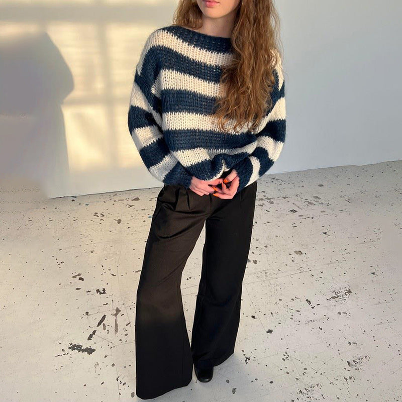 Striped crew-neck sweater in navy and white stripes worn with black trousers